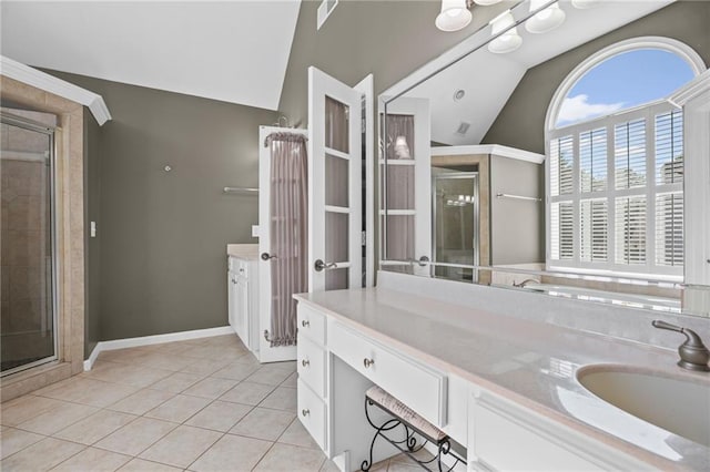 bathroom featuring vanity, a stall shower, vaulted ceiling, and visible vents
