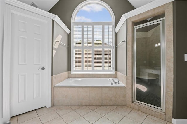 full bath featuring tile patterned floors, a shower stall, and a bath