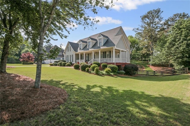 exterior space with a yard, fence, and covered porch