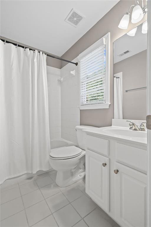 bathroom featuring toilet, visible vents, shower / bath combination with curtain, and vanity