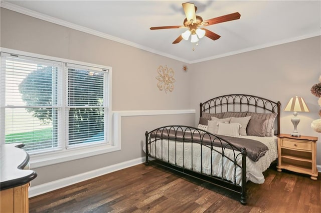 bedroom with baseboards, ornamental molding, a ceiling fan, and wood finished floors