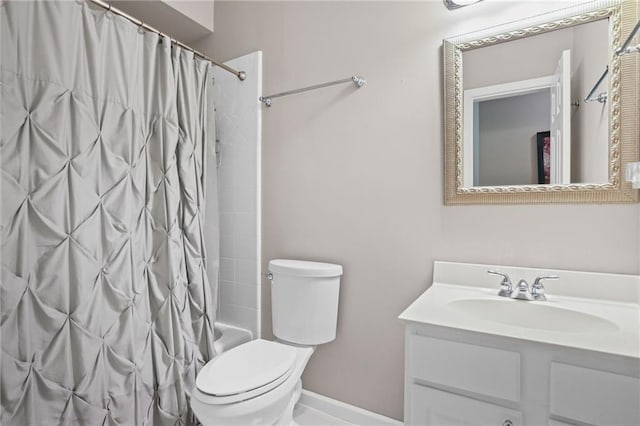 bathroom featuring toilet, baseboards, shower / bath combo with shower curtain, and vanity