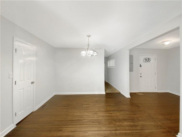 1879 Shamrock Dr, Decatur, GA 30032 - unfurnished room featuring electric panel, baseboards, a notable chandelier, and wood finished floors