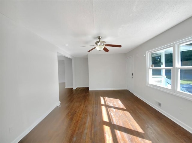1879 Shamrock Dr, Decatur, GA 30032 - empty room with a textured ceiling, visible vents, baseboards, wood finished floors, and a ceiling fan