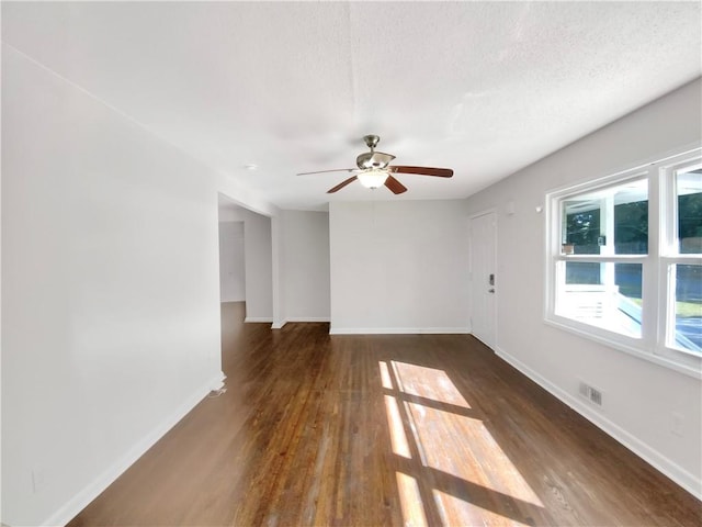 1879 Shamrock Dr, Decatur, GA 30032 - spare room with wood finished floors, a textured ceiling, baseboards, visible vents, and ceiling fan