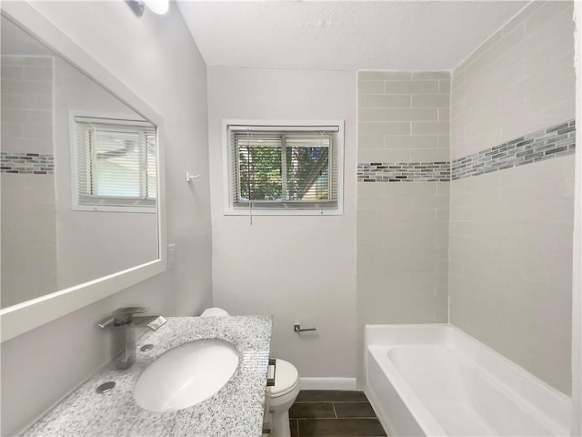 1879 Shamrock Dr, Decatur, GA 30032 - bathroom featuring washtub / shower combination, baseboards, toilet, and vanity