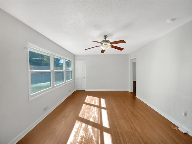 1879 Shamrock Dr, Decatur, GA 30032 - spare room with baseboards, wood finished floors, ceiling fan, and a textured ceiling