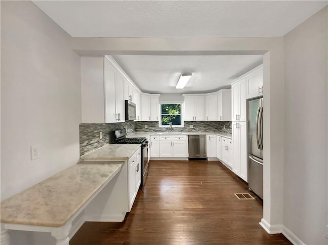 1879 Shamrock Dr, Decatur, GA 30032 - kitchen with light countertops, visible vents, tasteful backsplash, appliances with stainless steel finishes, and a sink