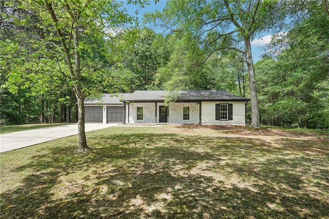 ranch-style home with an attached garage, concrete driveway, and a front lawn