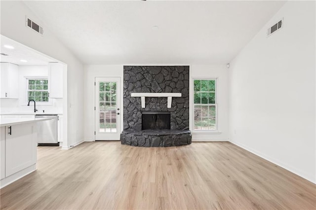 unfurnished living room with baseboards, visible vents, and light wood-style floors