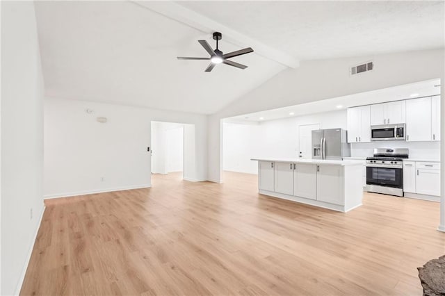 kitchen with visible vents, open floor plan, appliances with stainless steel finishes, and beam ceiling