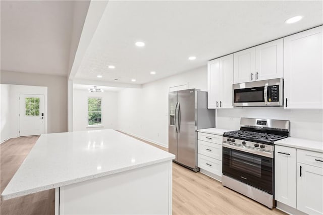 kitchen featuring appliances with stainless steel finishes, a center island, white cabinetry, recessed lighting, and light wood-type flooring