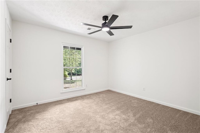 empty room with carpet flooring, baseboards, and ceiling fan