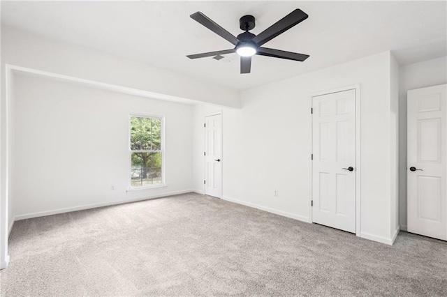 unfurnished bedroom with a ceiling fan, baseboards, and carpet