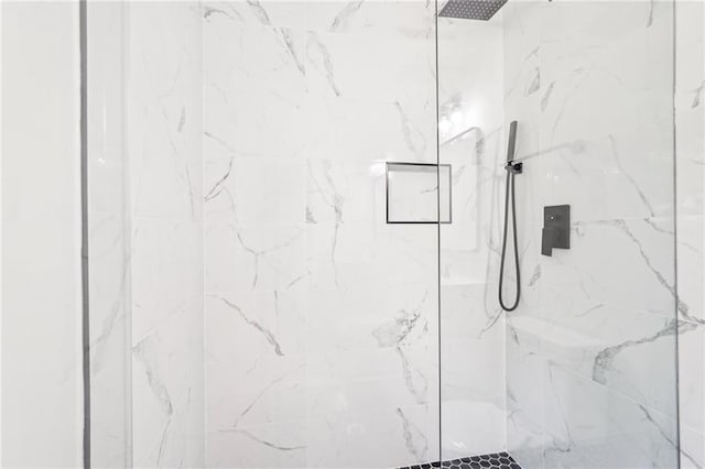 full bath with a marble finish shower