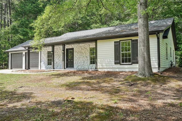 ranch-style home featuring driveway and a garage