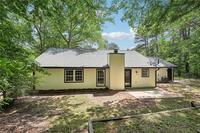 back of house with a patio, a chimney, and cooling unit