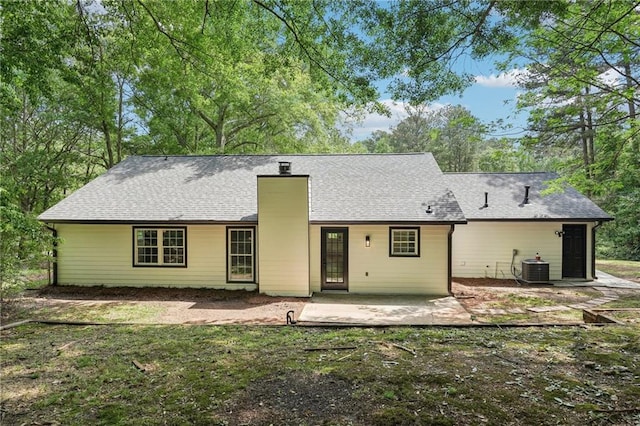 rear view of property with a patio, a chimney, and central AC unit