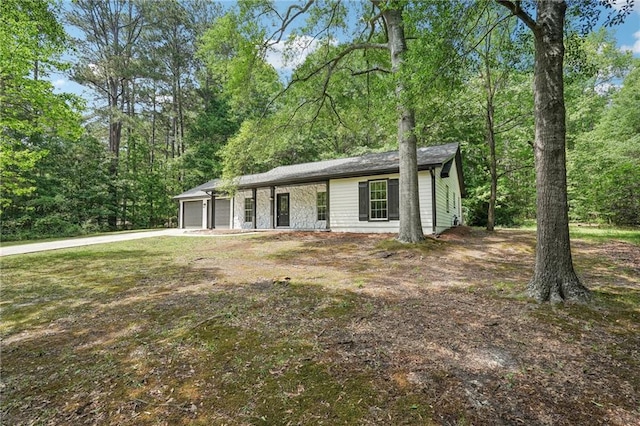 ranch-style home with an attached garage and driveway