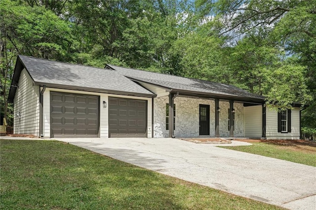 ranch-style home with a shingled roof, a front lawn, stone siding, a garage, and concrete driveway
