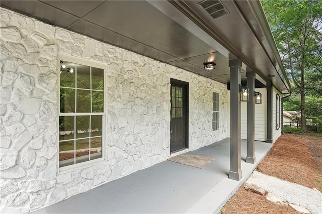 view of side of home featuring stone siding