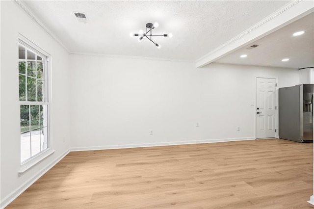 interior space featuring an inviting chandelier, baseboards, ornamental molding, and light wood-type flooring