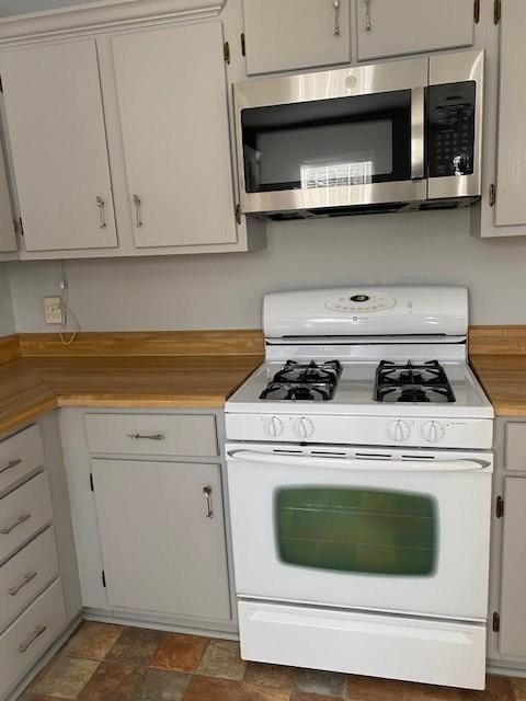 kitchen featuring white cabinetry and gas range gas stove