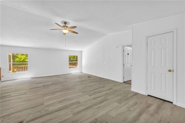 1437 Frank Lovell Rd, Clarkesville, GA 30523 - unfurnished living room featuring ceiling fan, a textured ceiling, baseboards, lofted ceiling, and light wood-type flooring