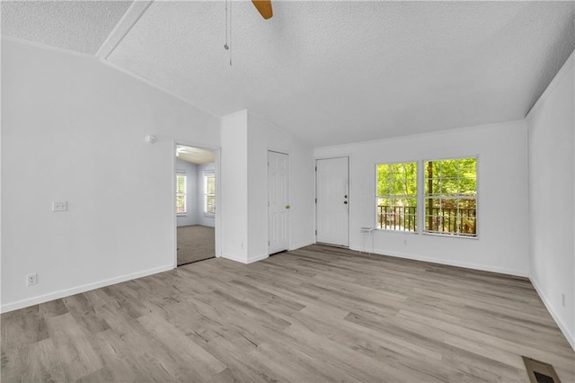 1437 Frank Lovell Rd, Clarkesville, GA 30523 - unfurnished living room with a ceiling fan, a textured ceiling, visible vents, vaulted ceiling, and wood finished floors