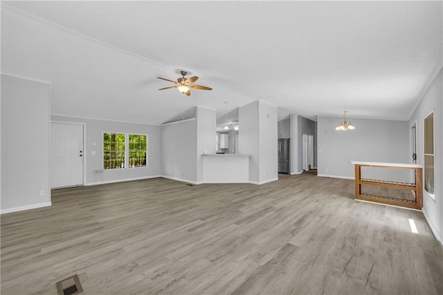 1437 Frank Lovell Rd, Clarkesville, GA 30523 - unfurnished living room featuring visible vents, light wood-type flooring, baseboards, ceiling fan with notable chandelier, and lofted ceiling