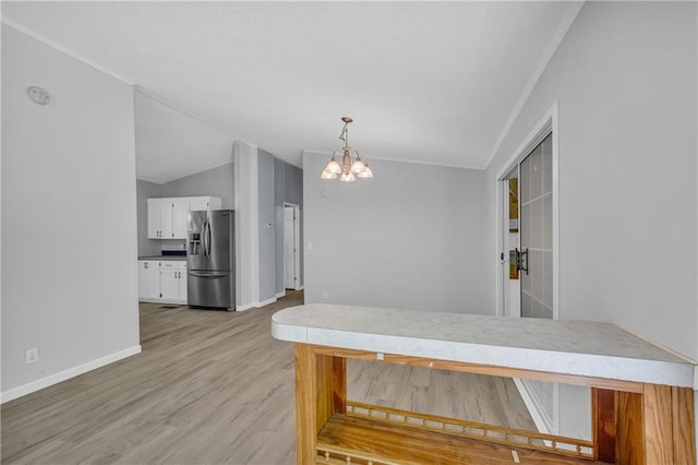 1437 Frank Lovell Rd, Clarkesville, GA 30523 - dining room with baseboards, vaulted ceiling, light wood finished floors, and a chandelier