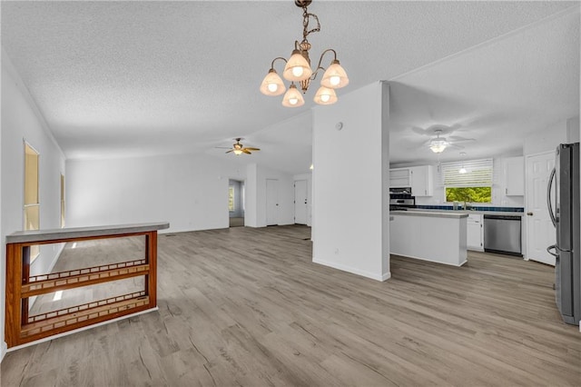 1437 Frank Lovell Rd, Clarkesville, GA 30523 - unfurnished living room with vaulted ceiling, ceiling fan with notable chandelier, light wood finished floors, and a textured ceiling