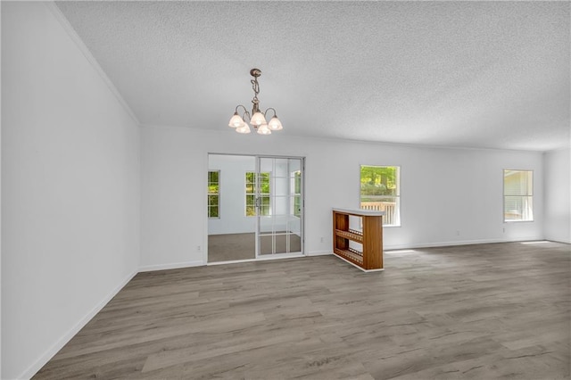 1437 Frank Lovell Rd, Clarkesville, GA 30523 - interior space with baseboards, a textured ceiling, wood finished floors, and a chandelier