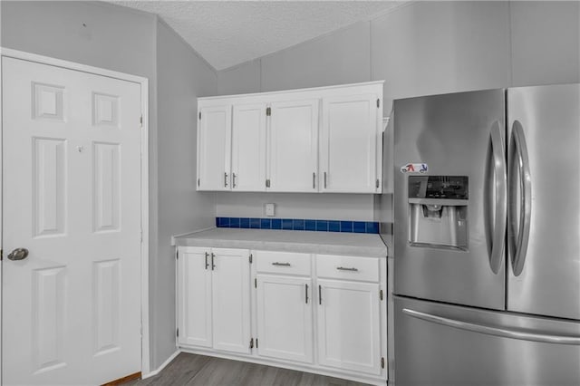 1437 Frank Lovell Rd, Clarkesville, GA 30523 - kitchen with dark wood-type flooring, light countertops, a textured ceiling, white cabinetry, and stainless steel fridge with ice dispenser