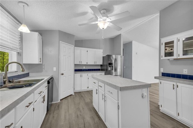 1437 Frank Lovell Rd, Clarkesville, GA 30523 - kitchen with ceiling fan, stainless steel fridge, a sink, light wood-style floors, and a textured ceiling