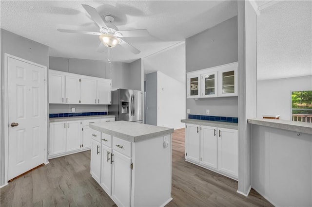 1437 Frank Lovell Rd, Clarkesville, GA 30523 - kitchen with a textured ceiling, wood finished floors, and stainless steel fridge with ice dispenser
