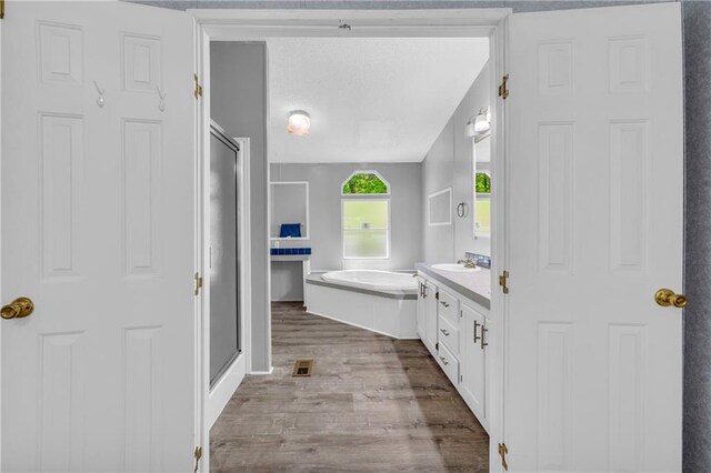 1437 Frank Lovell Rd, Clarkesville, GA 30523 - full bath featuring vanity, a garden tub, visible vents, wood finished floors, and a stall shower