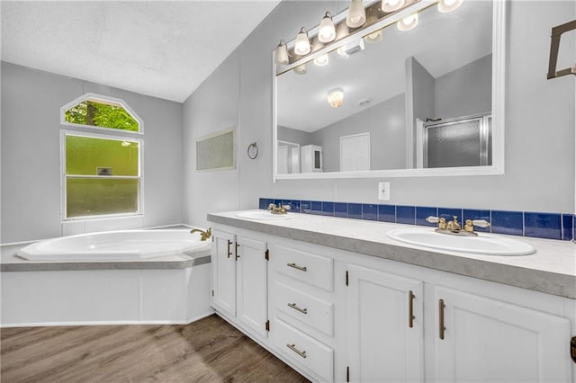 1437 Frank Lovell Rd, Clarkesville, GA 30523 - bathroom with a sink, wood finished floors, lofted ceiling, a garden tub, and a stall shower
