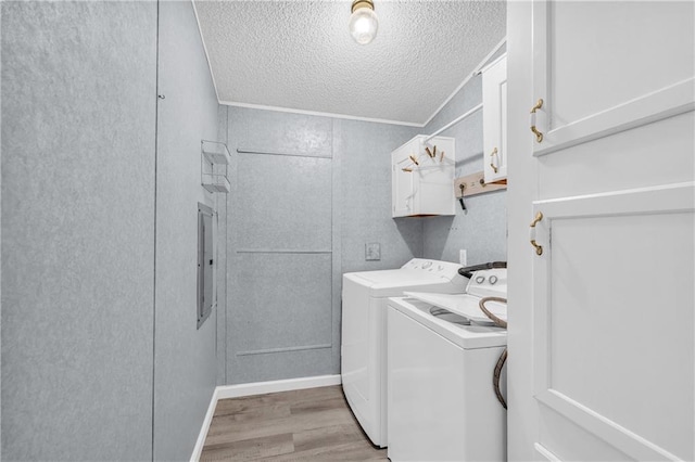 1437 Frank Lovell Rd, Clarkesville, GA 30523 - laundry area featuring electric panel, a textured ceiling, washing machine and dryer, cabinet space, and light wood-style floors
