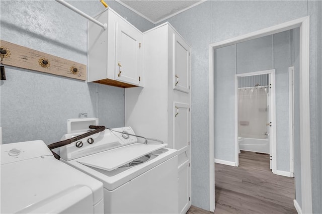 1437 Frank Lovell Rd, Clarkesville, GA 30523 - laundry room featuring baseboards, light wood finished floors, cabinet space, and washing machine and clothes dryer