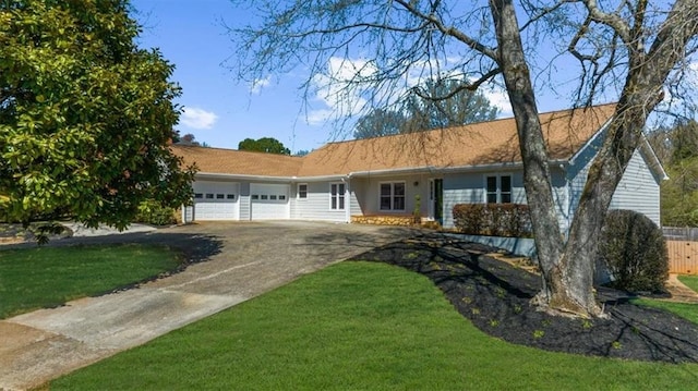 ranch-style house featuring a garage, concrete driveway, fence, and a front yard