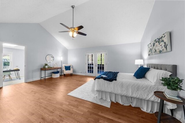 bedroom featuring multiple windows, wood finished floors, french doors, and access to outside