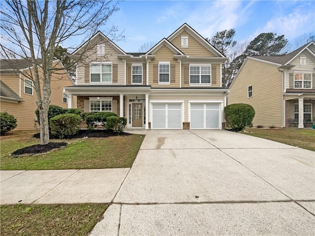 view of front of house featuring a front yard and a garage