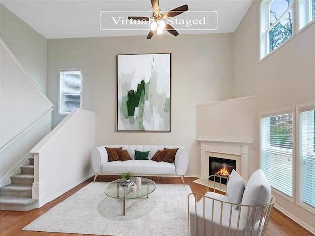 living room featuring hardwood / wood-style floors, ceiling fan, and plenty of natural light