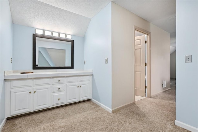 210 N Wesleyan Cir, Macon, GA 31210 - bathroom featuring vanity, carpet, a textured ceiling, and vaulted ceiling