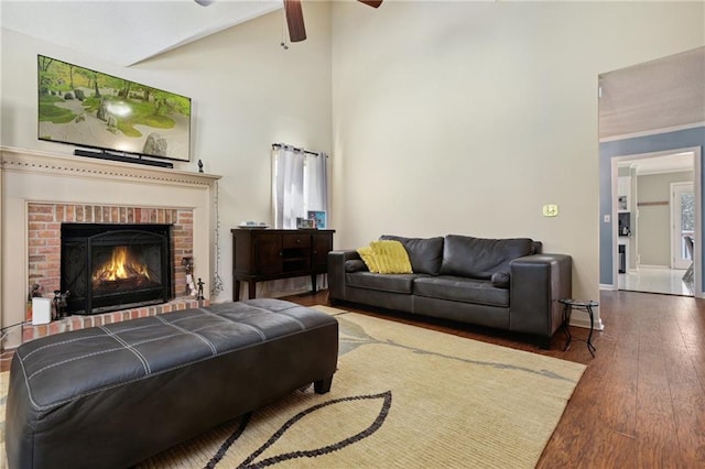 210 N Wesleyan Cir, Macon, GA 31210 - living room featuring wood finished floors, ceiling fan, a fireplace, beamed ceiling, and high vaulted ceiling
