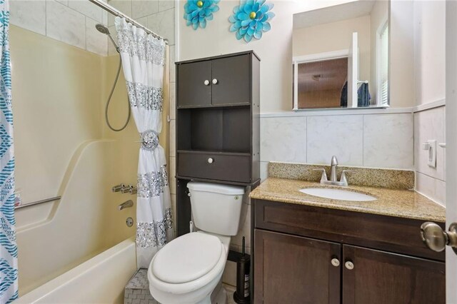 full bathroom with tasteful backsplash, shower / tub combo with curtain, vanity, and toilet