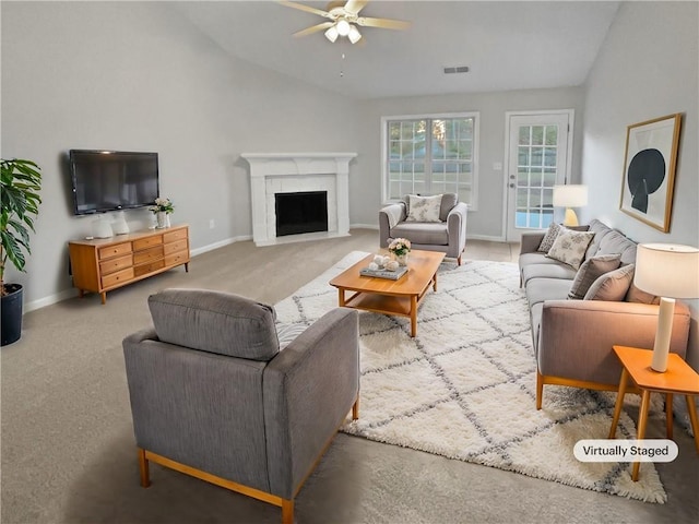 living room with ceiling fan, carpet, and vaulted ceiling