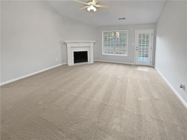 unfurnished living room with ceiling fan, light carpet, and lofted ceiling