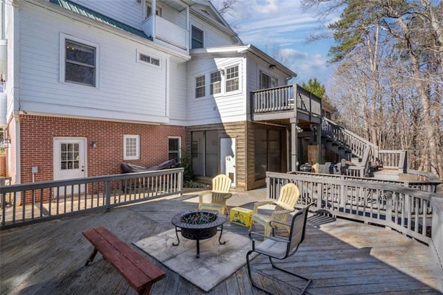 wooden terrace with a fire pit